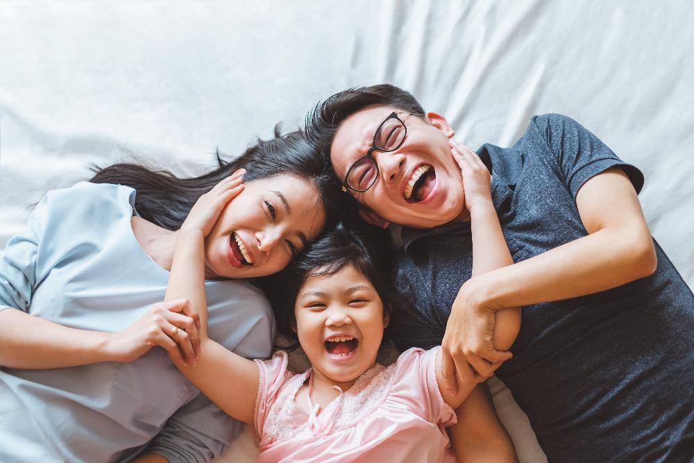 family of three hugging | dental fillings brooklyn